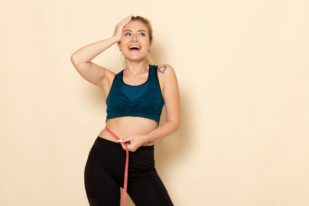 Woman celebrating progress in activewear