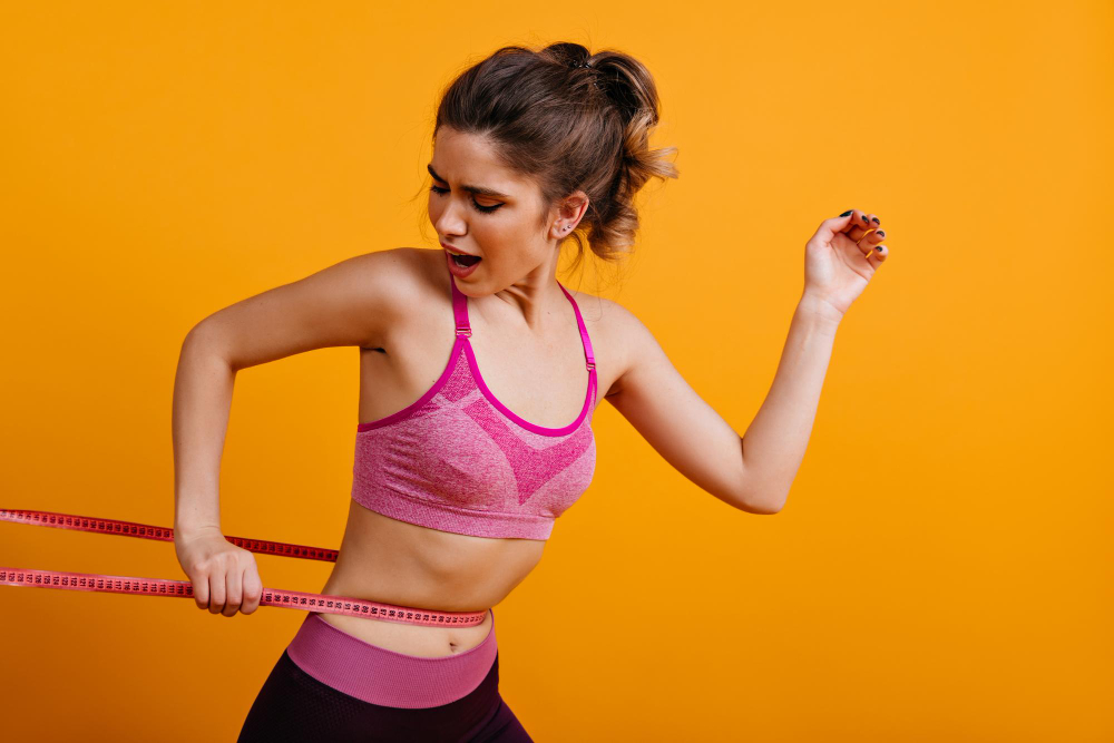 Active woman measuring her waist during a wellness routine